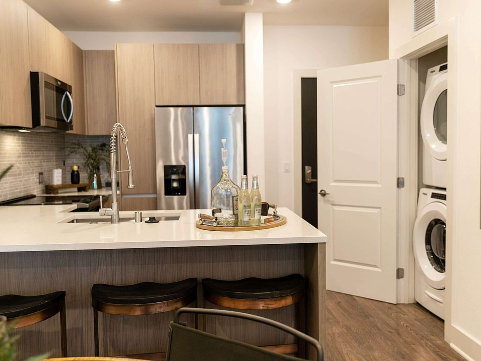 Enjoy the ease of modern living with a sleek kitchen layout and convenient in-unit washer and dryer just steps away.