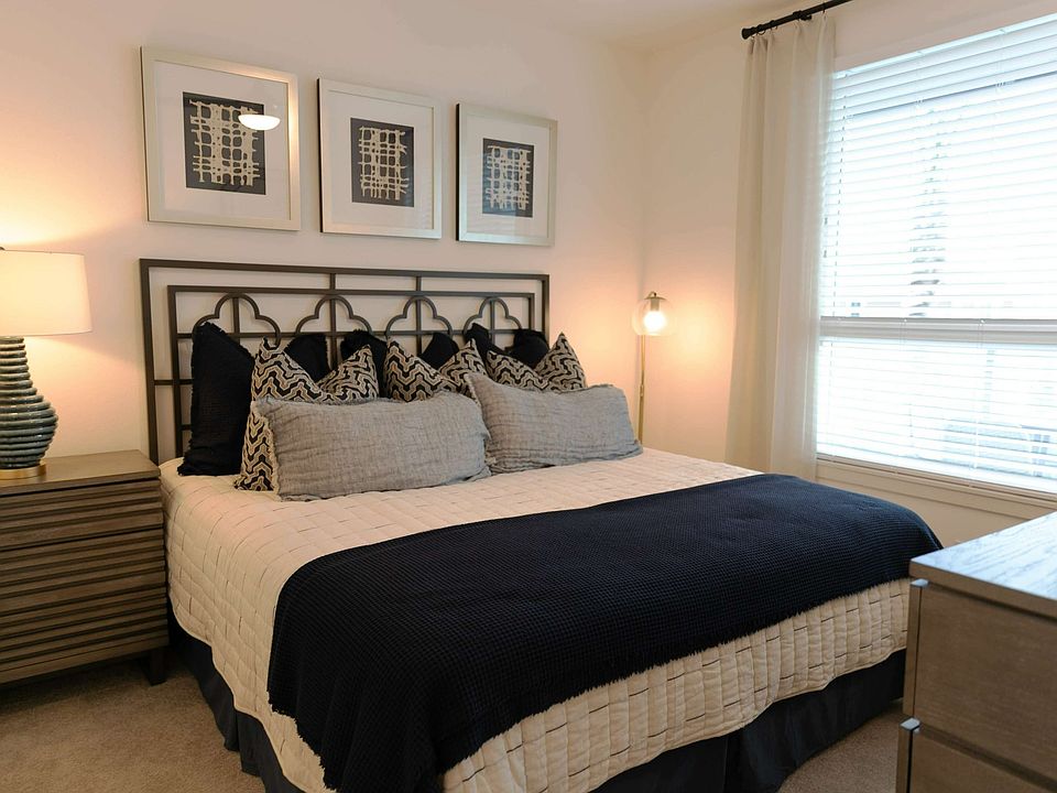 Rest easy in a thoughtfully designed bedroom featuring soft lighting, cozy textures, and modern finishes.
