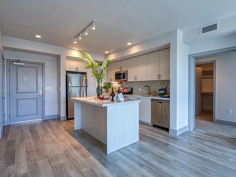 Open kitchen with a chef island, bright finishes, and plenty of room for casual gathering.