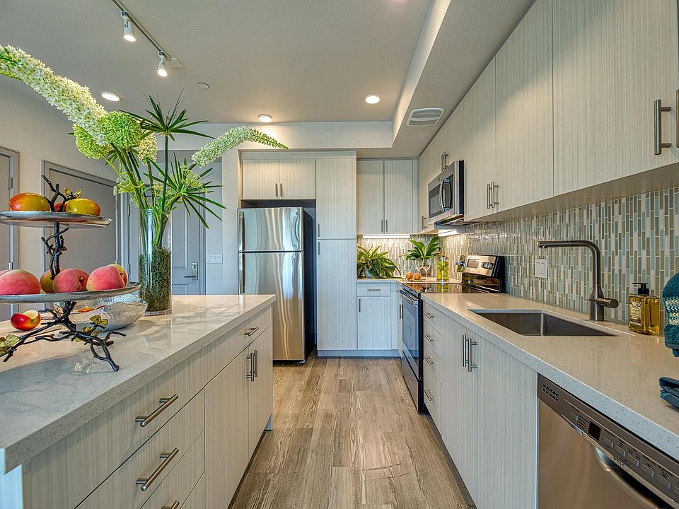 Light filled kitchen with granite counters, energy efficient appliances, and a clean, streamlined design.