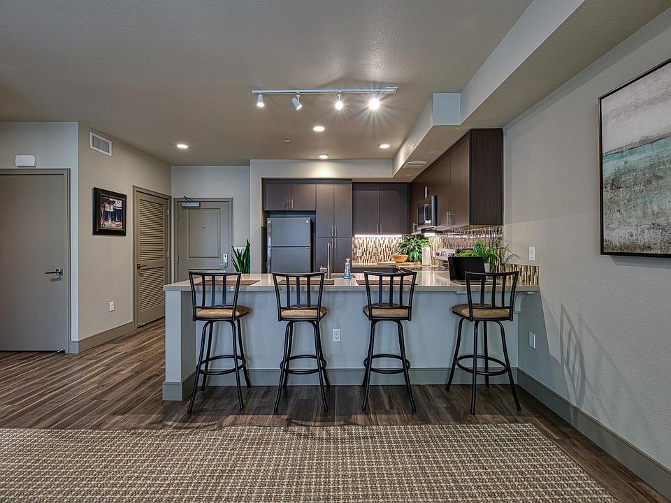 Spacious bar seating opens to an open concept kitchen, creating an inviting spot for casual dining.