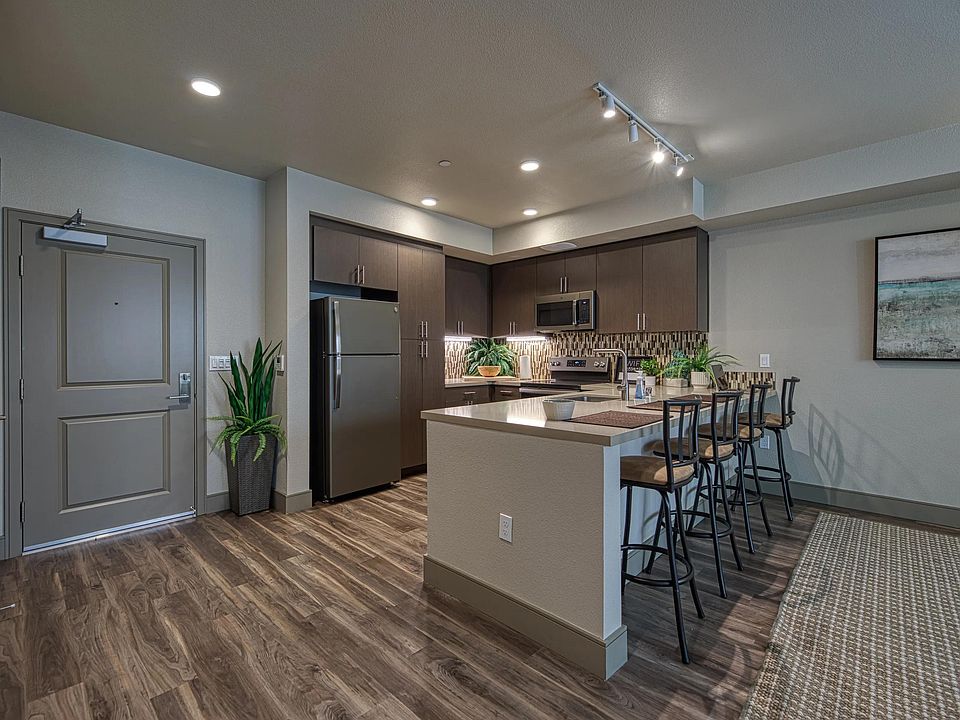 Warm kitchen entry with a chef island, open layout, and seating that supports easy conversation and meals.